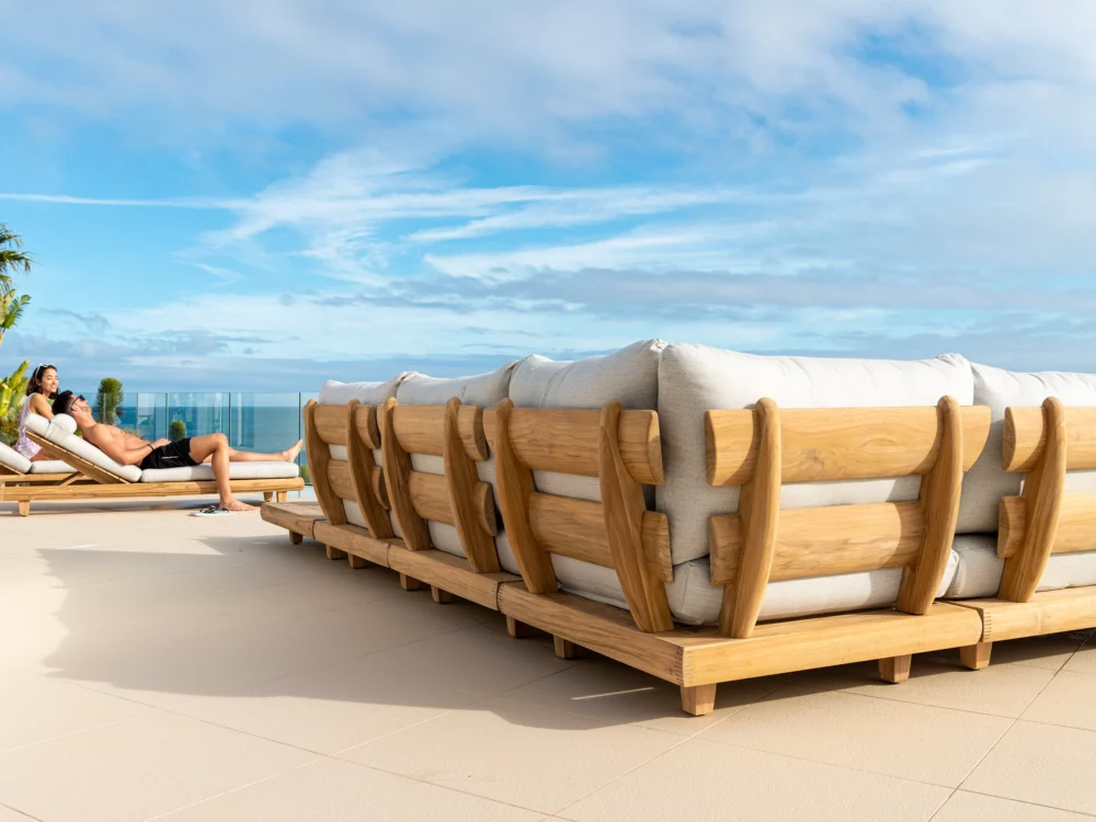 Alexander Rose Sorrento Modular Set Couple relaxing on Sorrento Sun loungers Luxury Teak Garden Furniture