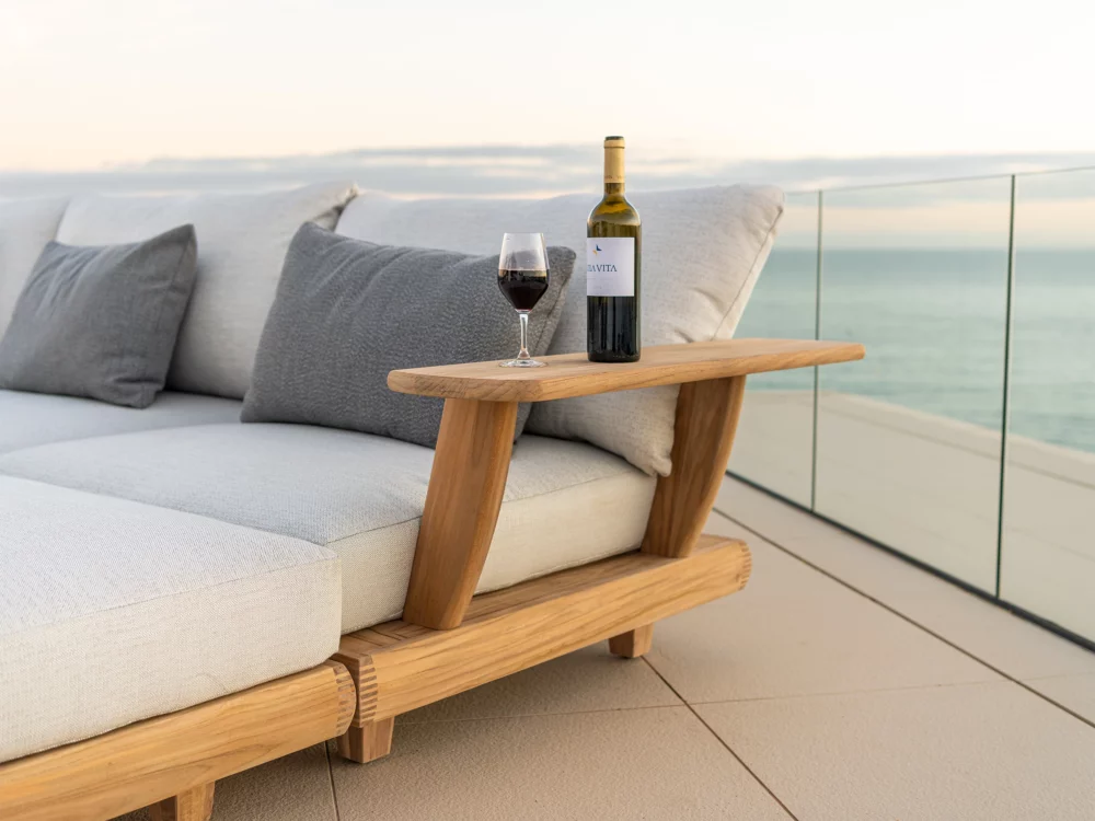 Alexander Rose Sorrento Modular Set Bottle of red wine resting on arm of the lounger Luxury Teak Garden Furniture